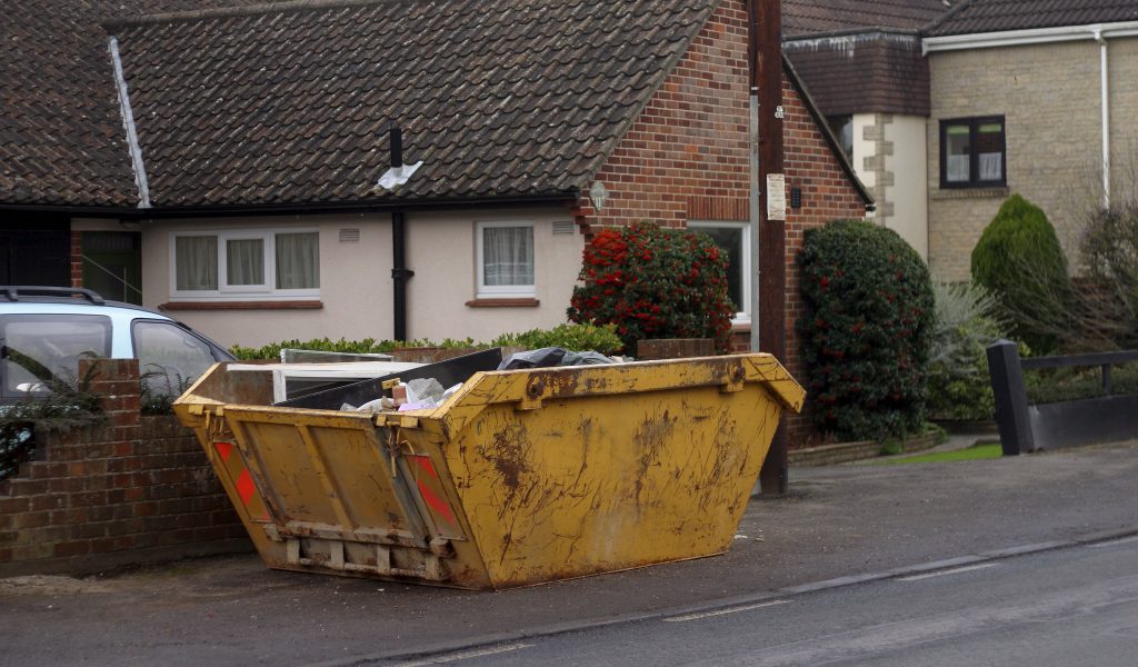 a skip placed outside a home on road